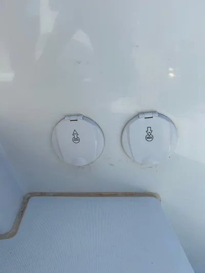  Yacht Photos Pics 2024 Lagoon 46 yacht water and waste ports on white exterior.