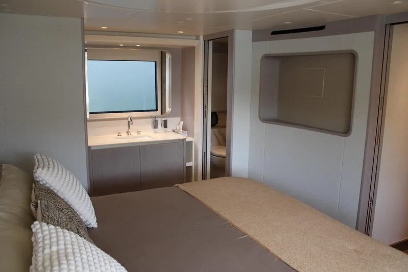  Yacht Photos Pics Luxurious interior of 2025 Absolute NAVETTA 70 yacht with modern bedroom and ensuite bathroom.