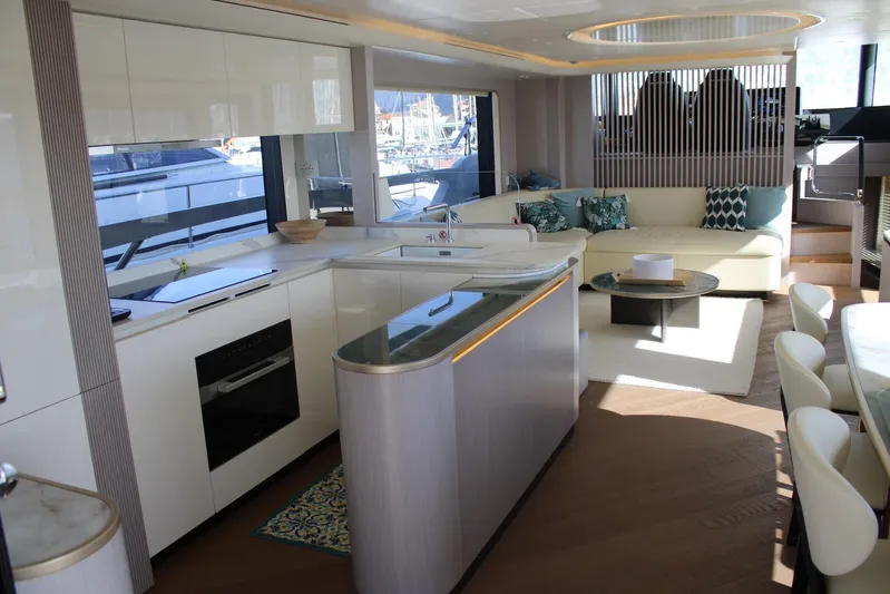  Yacht Photos Pics Luxurious interior of 2025 Absolute NAVETTA 70 yacht with modern kitchen and seating area.