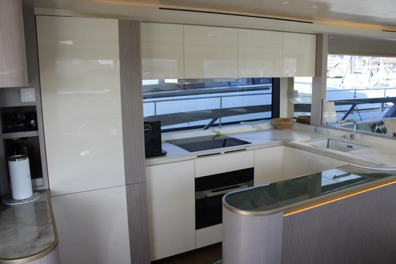  Yacht Photos Pics Modern kitchen interior on 2025 Absolute NAVETTA 70 yacht, featuring sleek cabinetry and appliances.
