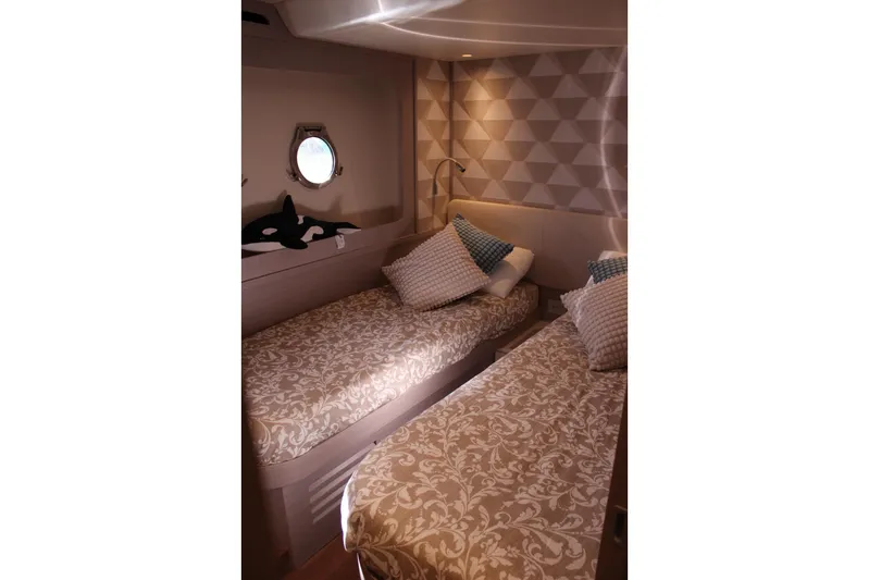  Yacht Photos Pics Luxurious twin cabin on 2025 Absolute NAVETTA 70 yacht with elegant bedding and porthole.