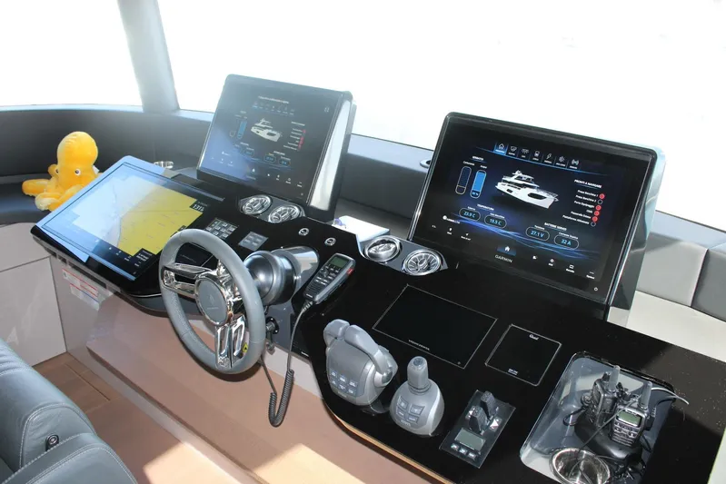  Yacht Photos Pics Modern helm of 2025 Absolute NAVETTA 70 yacht with advanced navigation displays.