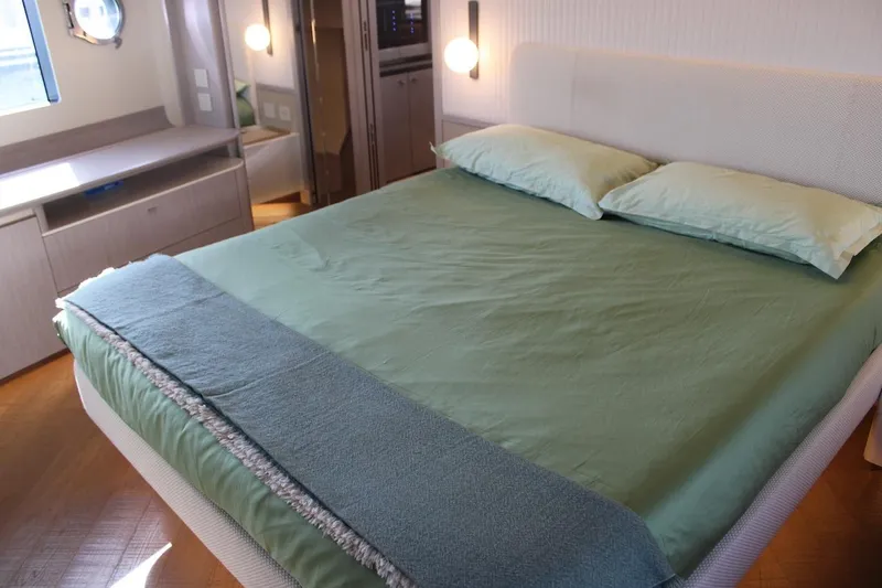  Yacht Photos Pics Luxurious bedroom interior on Absolute NAVETTA 70 yacht, 2025 model, featuring a cozy bed.