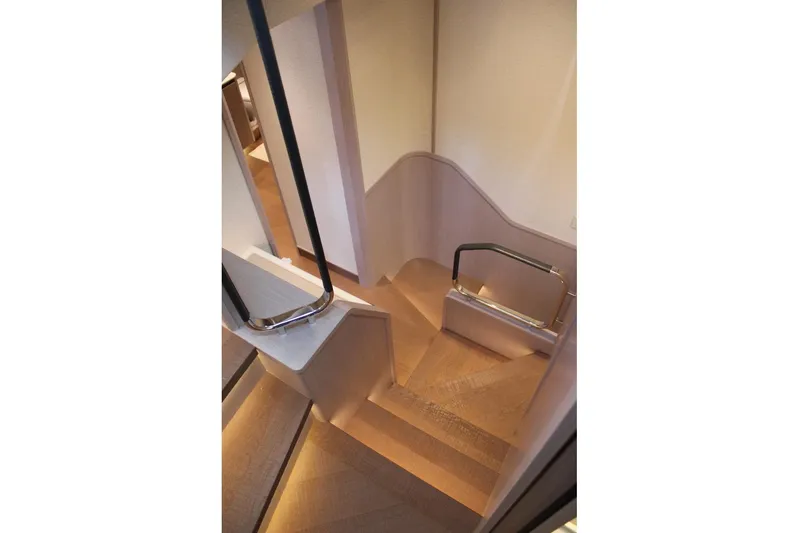  Yacht Photos Pics Elegant interior staircase of 2025 Absolute NAVETTA 70 yacht, featuring sleek design and modern handrails.