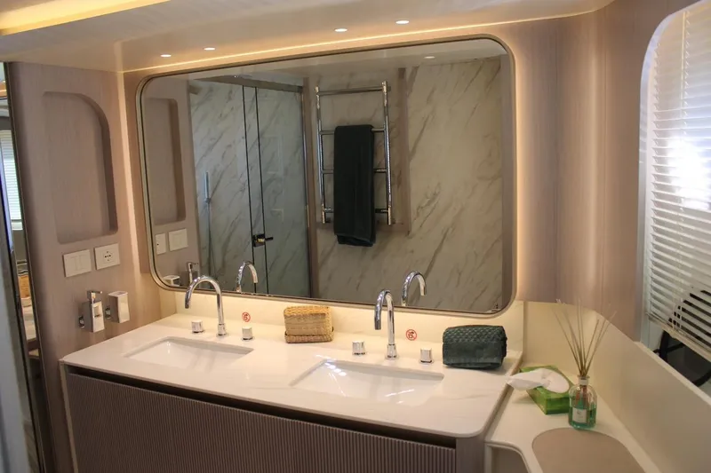  Yacht Photos Pics Luxurious bathroom in 2025 Absolute NAVETTA 70 yacht with dual sinks and elegant decor.