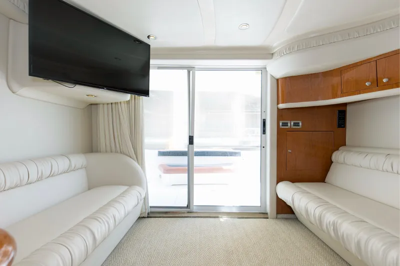 Silver Lining Yacht Photos Pics Interior of 2000 Sea Ray 400 Sedan Bridge with white seating and mounted TV.