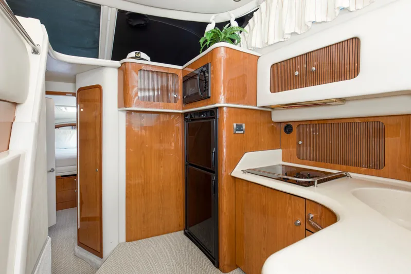 Silver Lining Yacht Photos Pics Interior of 2000 Sea Ray 400 Sedan Bridge yacht, featuring a compact kitchen area.