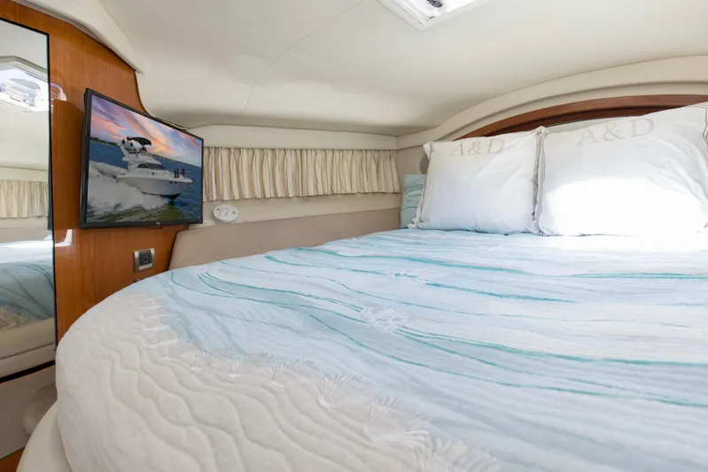 Silver Lining Yacht Photos Pics Luxurious bedroom interior of 2000 Sea Ray 400 Sedan Bridge yacht with TV and cozy bedding.