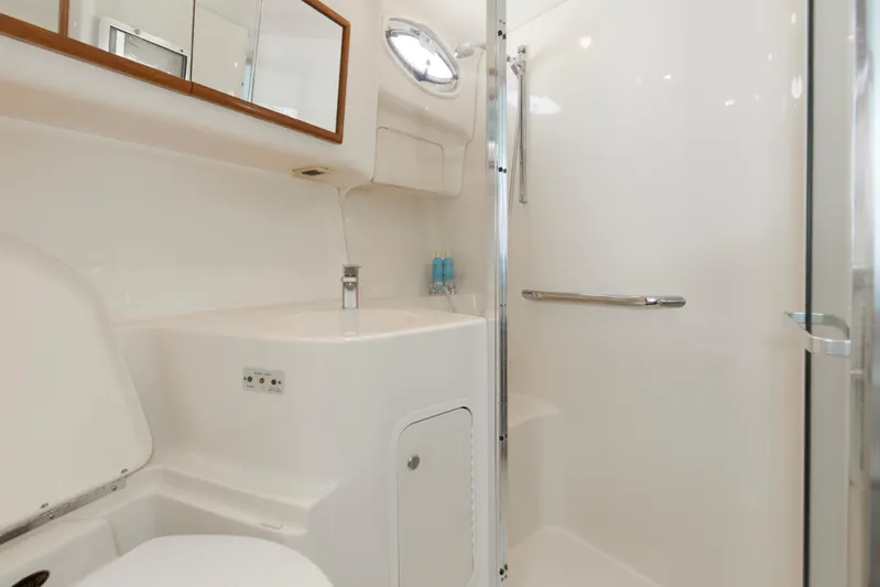 Silver Lining Yacht Photos Pics Bathroom interior of 2000 Sea Ray 400 Sedan Bridge yacht, featuring shower and sink.