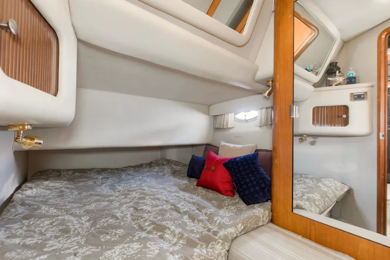 Silver Lining Yacht Photos Pics Cozy cabin interior of 2000 Sea Ray 400 Sedan Bridge with plush bedding and pillows.