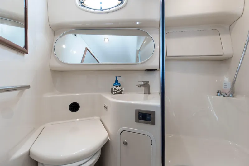 Silver Lining Yacht Photos Pics 2000 Sea Ray 400 Sedan Bridge bathroom with modern fixtures and mirror.