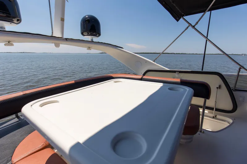 Silver Lining Yacht Photos Pics 2000 Sea Ray 400 Sedan Bridge yacht with outdoor seating and table, overlooking calm waters.