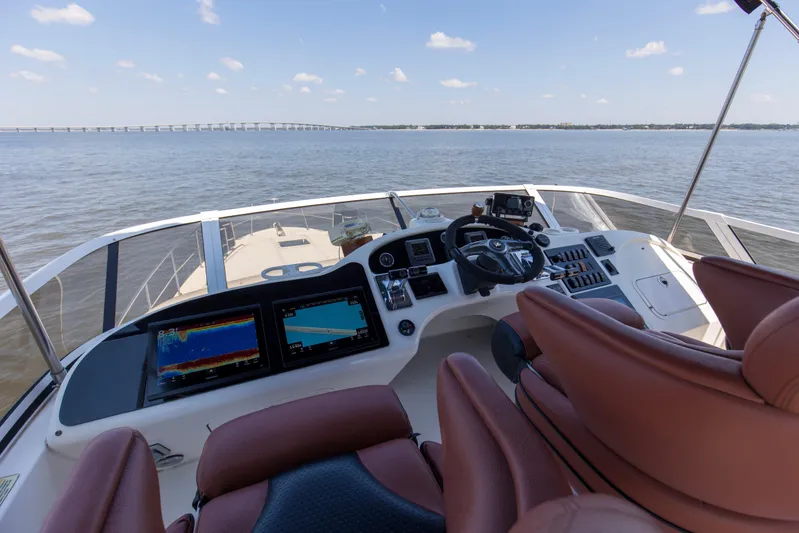 Silver Lining Yacht Photos Pics Cockpit view of 2000 Sea Ray 400 Sedan Bridge yacht with navigation screens and steering wheel.
