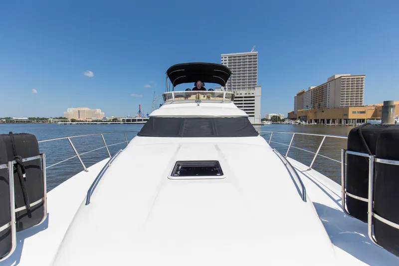 Silver Lining Yacht Photos Pics 2000 Sea Ray 400 Sedan Bridge yacht on water with cityscape background.