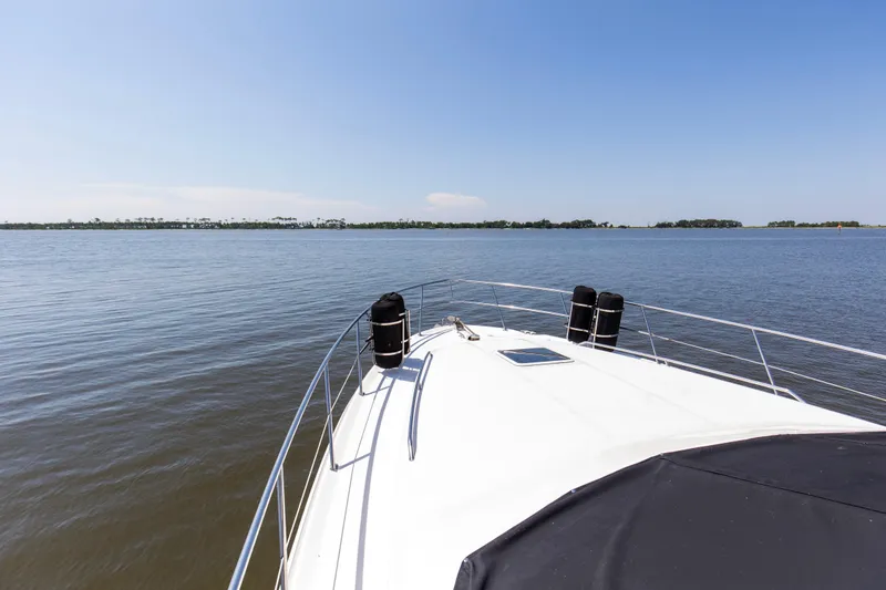 Silver Lining Yacht Photos Pics Bow view of 2000 Sea Ray 400 Sedan Bridge on calm waters under clear sky.