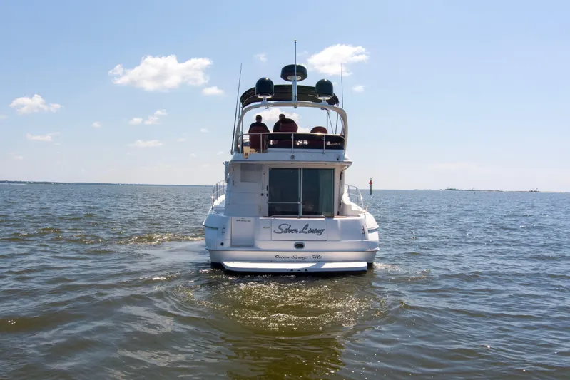 Silver Lining Yacht Photos Pics 2000 Sea Ray 400 Sedan Bridge cruising on open water under a clear sky.
