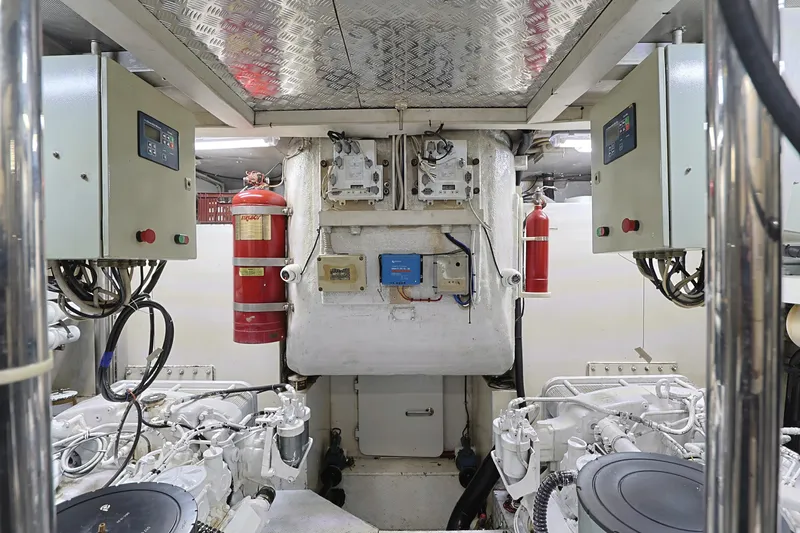 Julia Too Yacht Photos Pics Engine room of 2002 Azimut 70 Sea Jet yacht with control panels and fire extinguishers.