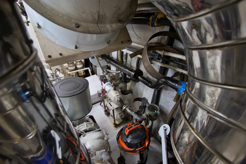 Julia Too Yacht Photos Pics Engine room of a 2002 Azimut 70 Sea Jet yacht with visible machinery and pipes.