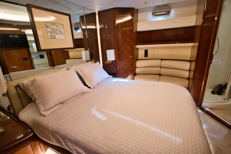Julia Too Yacht Photos Pics Luxurious bedroom interior of 2002 Azimut 70 Sea Jet yacht with elegant furnishings.