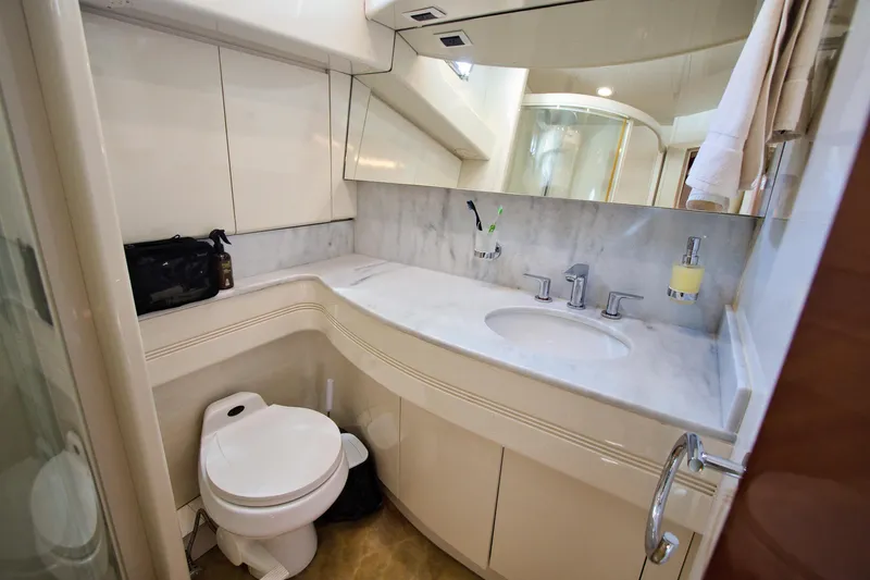 Julia Too Yacht Photos Pics Luxurious bathroom in 2002 Azimut 70 Sea Jet yacht with modern fixtures and marble countertop.