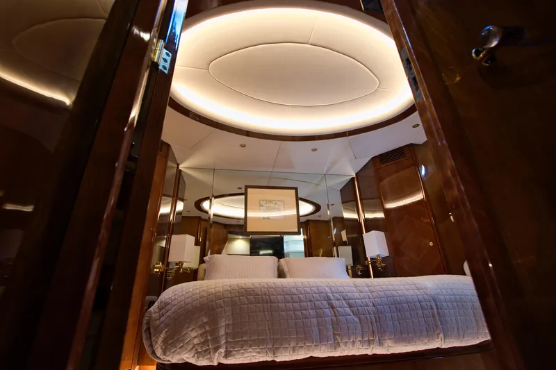 Julia Too Yacht Photos Pics Luxurious bedroom interior of 2002 Azimut 70 Sea Jet yacht with elegant lighting.