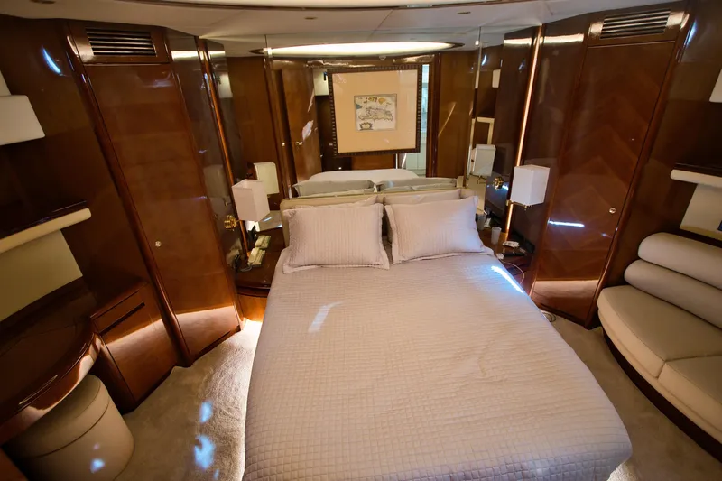 Julia Too Yacht Photos Pics Luxurious bedroom interior of a 2002 Azimut 70 Sea Jet yacht with elegant wood finishes.