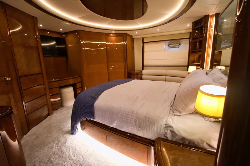 Julia Too Yacht Photos Pics Luxurious bedroom interior of 2002 Azimut 70 Sea Jet yacht with elegant wood finishes.