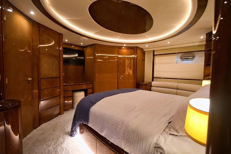 Julia Too Yacht Photos Pics Luxurious bedroom interior of 2002 Azimut 70 Sea Jet yacht with elegant wood finishes.