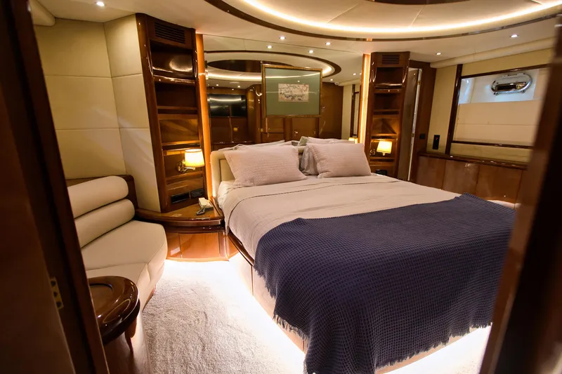 Julia Too Yacht Photos Pics Luxurious bedroom interior of 2002 Azimut 70 Sea Jet yacht with elegant furnishings.