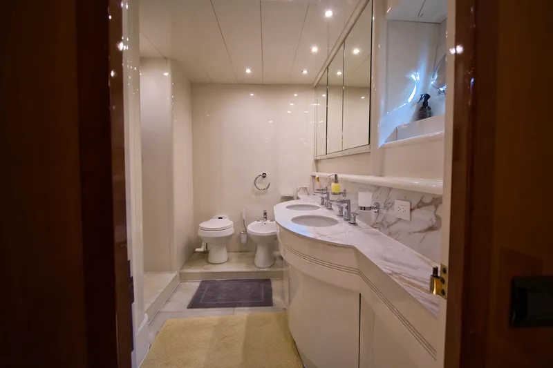 Julia Too Yacht Photos Pics Luxurious bathroom on 2002 Azimut 70 Sea Jet yacht with marble countertops and modern fixtures.