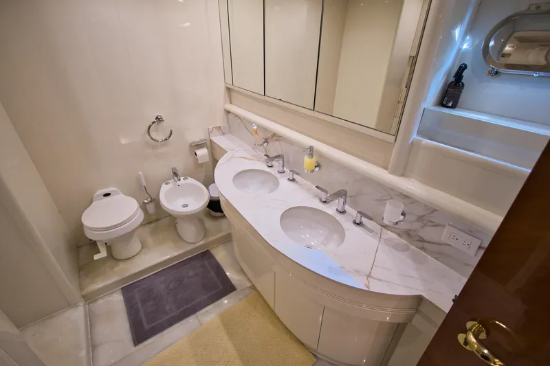 Julia Too Yacht Photos Pics Luxurious bathroom on 2002 Azimut 70 Sea Jet yacht with marble countertop and dual sinks.
