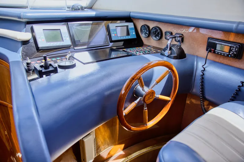 Julia Too Yacht Photos Pics Cockpit of 2002 Azimut 70 Sea Jet yacht with wooden steering wheel and navigation controls.