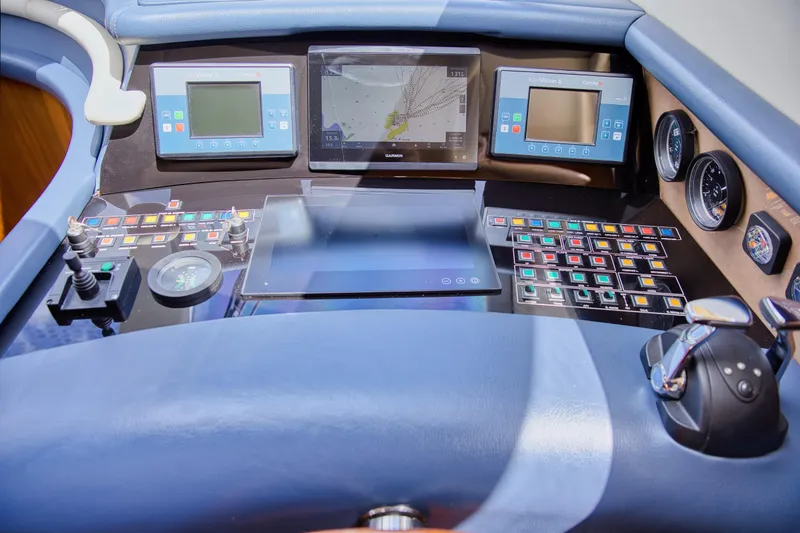 Julia Too Yacht Photos Pics Control panel of a 2002 Azimut 70 Sea Jet yacht with navigation screens and gauges.