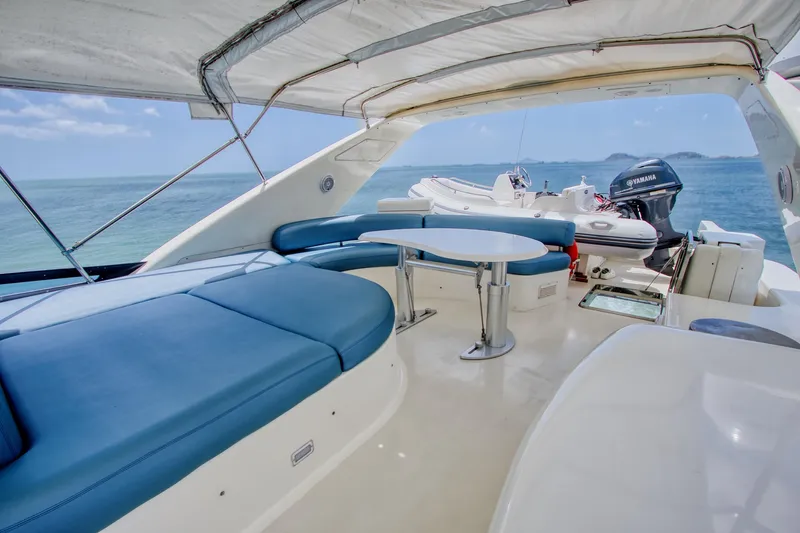 Julia Too Yacht Photos Pics Luxurious 2002 Azimut 70 Sea Jet yacht interior with blue seating and ocean view.