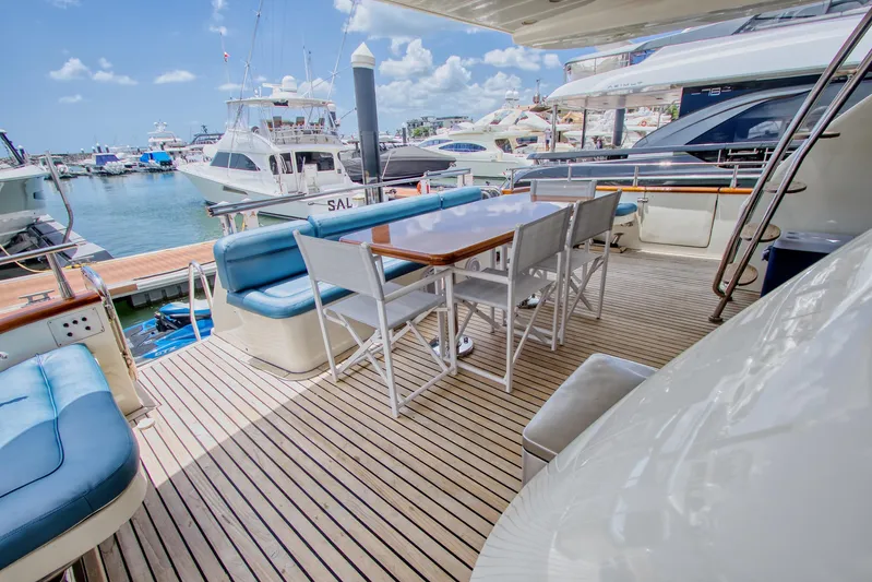 Julia Too Yacht Photos Pics Luxurious 2002 Azimut 70 Sea Jet yacht deck with seating and dining area in marina.