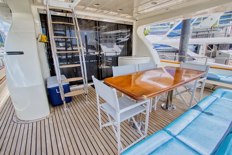 Julia Too Yacht Photos Pics Luxurious 2002 Azimut 70 Sea Jet yacht deck with dining area and ladder.