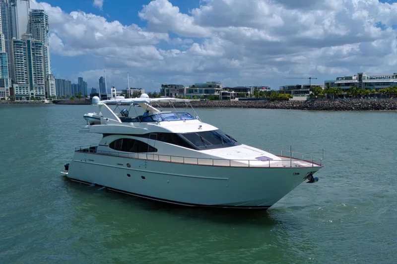 Julia Too Yacht Photos Pics Azimut 70 Sea Jet 2002 yacht cruising near modern city skyline and waterfront.