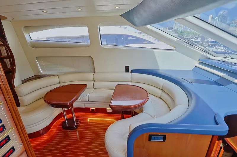 Julia Too Yacht Photos Pics Luxurious interior of a 2002 Azimut 70 Sea Jet yacht with elegant seating and wooden accents.