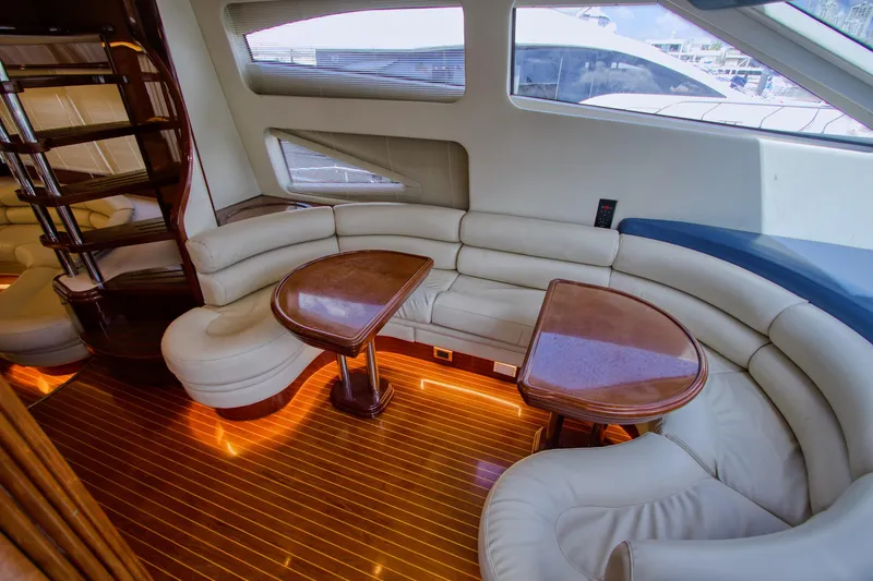 Julia Too Yacht Photos Pics Luxurious interior of 2002 Azimut 70 Sea Jet yacht with elegant seating and wooden tables.