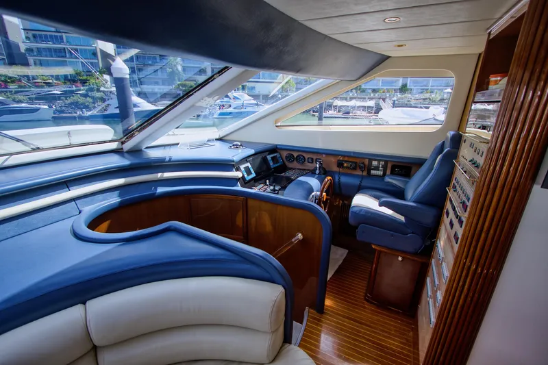 Julia Too Yacht Photos Pics Luxurious interior of 2002 Azimut 70 Sea Jet yacht with modern helm and seating.