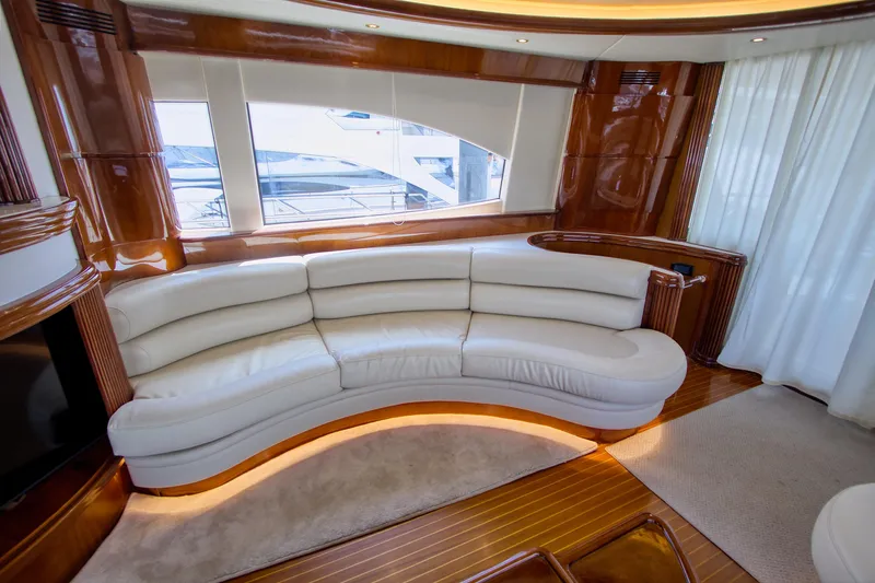 Julia Too Yacht Photos Pics Luxurious interior of 2002 Azimut 70 Sea Jet yacht with curved white leather sofa.