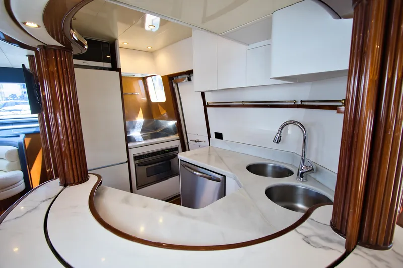 Julia Too Yacht Photos Pics Luxurious kitchen interior of 2002 Azimut 70 Sea Jet yacht with modern amenities.