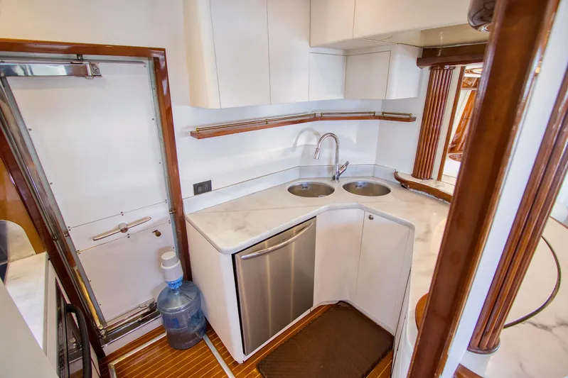 Julia Too Yacht Photos Pics Compact kitchen area on 2002 Azimut 70 Sea Jet yacht with dual sinks and modern cabinetry.