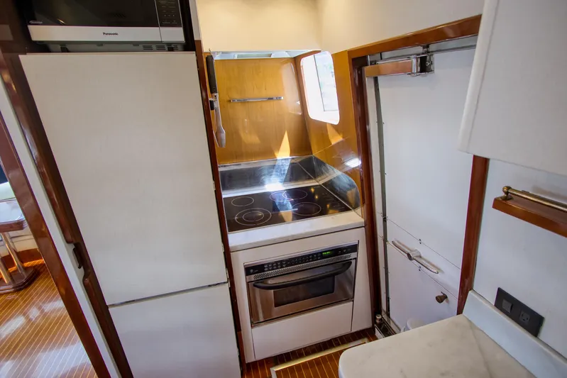 Julia Too Yacht Photos Pics Compact kitchen in 2002 Azimut 70 Sea Jet yacht with stove and microwave.