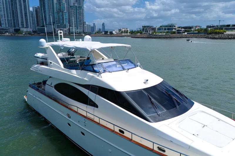 Julia Too Yacht Photos Pics 2002 Azimut 70 Sea Jet yacht cruising near urban skyline.