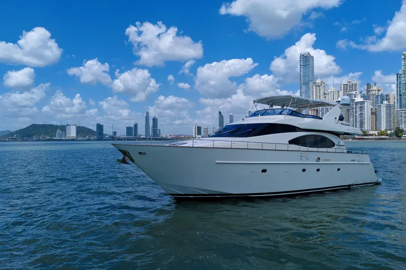 Julia Too Yacht Photos Pics Azimut 70 Sea Jet 2002 yacht cruising near city skyline under blue sky.
