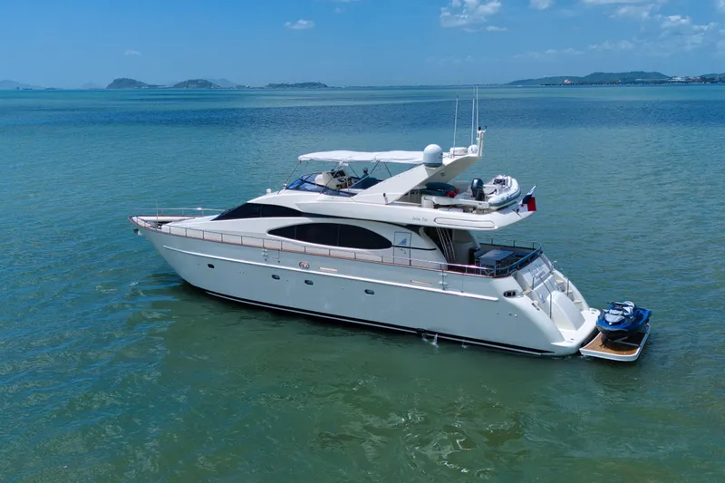 Julia Too Yacht Photos Pics 2002 Azimut 70 Sea Jet yacht on calm blue waters under clear sky.