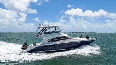  Yacht Photos Pics 2005 Sea Ray 52 Sedan Bridge yacht cruising on open water under a clear blue sky.