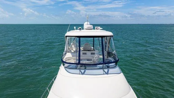  Yacht Photos Pics 2005 Sea Ray 52 Sedan Bridge yacht cruising on open water under clear skies.