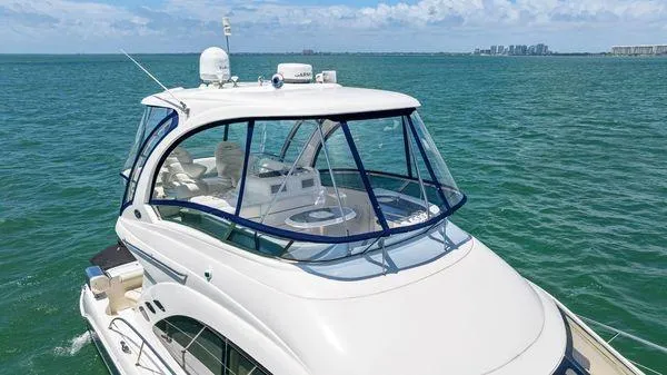  Yacht Photos Pics 2005 Sea Ray 52 Sedan Bridge yacht cruising on open water.